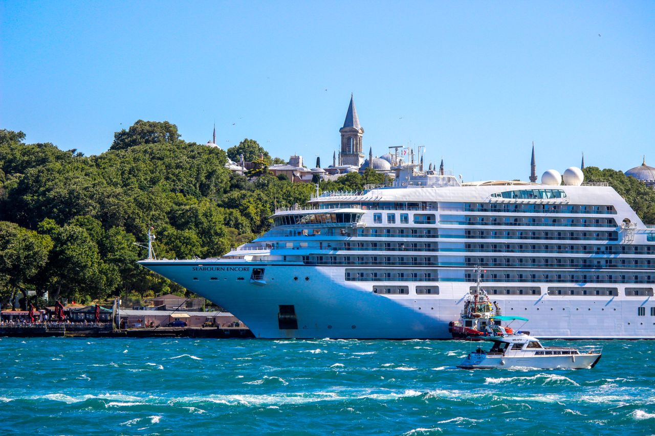 The Art of Drawing Readers In: Your attractive post title goes here A majestic cruise ship sails through the Bosphorus Strait with a historic Istanbul skyline in the backdrop.