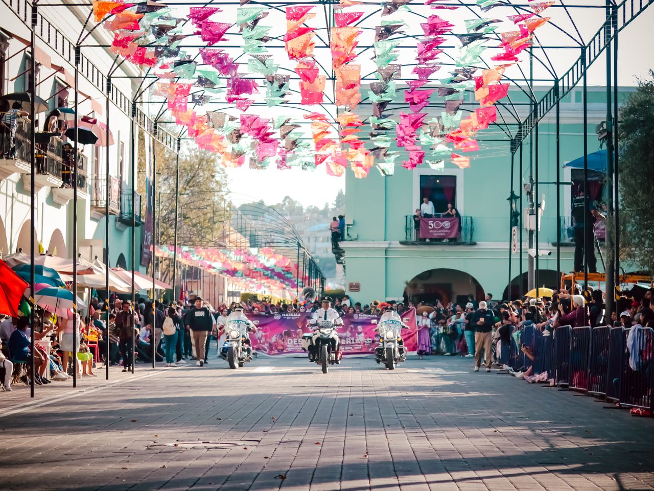Crafting Captivating Headlines: Your awesome post title goes here Vibrant street parade with colorful flags and motorbikes on a sunny day.